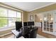 Bright home office with french doors, large window and a dark desk set at 11872 Traymoore Dr, Fishers, IN 46038