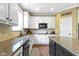 Bright kitchen with granite counters, white cabinets, and stainless steel appliances at 11872 Traymoore Dr, Fishers, IN 46038