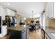 Open kitchen with granite countertops, island and views into living room and dining area at 11872 Traymoore Dr, Fishers, IN 46038