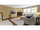 Cozy living room with a fireplace, large windows, and comfortable seating at 11872 Traymoore Dr, Fishers, IN 46038