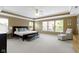 Spacious main bedroom with a tray ceiling, large windows, and comfortable furnishings at 11872 Traymoore Dr, Fishers, IN 46038