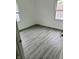 Bright bedroom featuring gray wood-look flooring and white walls at 1322 S Belmont Ave, Indianapolis, IN 46221