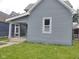 Gray two-story home featuring a covered porch and horizontal siding at 1322 S Belmont Ave, Indianapolis, IN 46221