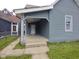Gray two-story home featuring a covered porch and horizontal siding at 1322 S Belmont Ave, Indianapolis, IN 46221