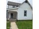 Charming home featuring white siding, a welcoming front porch, and a well-maintained lawn at 1322 S Belmont Ave, Indianapolis, IN 46221