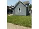 Charming home featuring light gray siding, a well-manicured lawn, and a bright white window frame at 1322 S Belmont Ave, Indianapolis, IN 46221