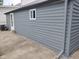 View of gray detached garage with white trim and concrete driveway at 1322 S Belmont Ave, Indianapolis, IN 46221