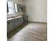 Kitchen featuring gray cabinets, stainless sink, and gray wood-look flooring at 1322 S Belmont Ave, Indianapolis, IN 46221
