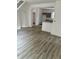 Open-concept living room with gray wood floors and neutral walls connects to the kitchen at 1322 S Belmont Ave, Indianapolis, IN 46221