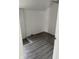 Empty room showcasing gray wood-look flooring and white walls and trim at 1322 S Belmont Ave, Indianapolis, IN 46221
