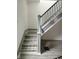 View of stairway with gray wood-look treads and gray and white trim at 1322 S Belmont Ave, Indianapolis, IN 46221