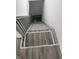 View of stairway with gray wood-look treads and gray and white trim at 1322 S Belmont Ave, Indianapolis, IN 46221