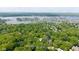 Aerial view of home, property lines, and nearby Geist Reservoir in a wooded location at 13300 Fairwood Dr, McCordsville, IN 46055