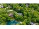 Stunning aerial view of a lushly wooded estate with a serene pond at 13300 Fairwood Dr, McCordsville, IN 46055