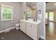 The main bathroom features a double sink vanity, a large mirror and tiled floors at 13300 Fairwood Dr, McCordsville, IN 46055
