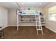Bedroom with a lofted twin bed, desk, shelving, and window for a functional space at 13300 Fairwood Dr, McCordsville, IN 46055