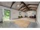 Large bonus room or flex space featuring concrete floors and high vaulted ceiling with exposed rafters at 13300 Fairwood Dr, McCordsville, IN 46055
