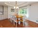 Bright dining room with wood floors, large windows, and modern light fixture at 13300 Fairwood Dr, McCordsville, IN 46055