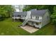 Back of home featuring a spacious deck, stairs, and lush lawn at 13300 Fairwood Dr, McCordsville, IN 46055
