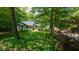 Charming ranch-style home nestled in a wooded area with a well-manicured lawn at 13300 Fairwood Dr, McCordsville, IN 46055