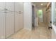 Inviting hallway with built-in cabinets, tiled floor, and natural light at 13300 Fairwood Dr, McCordsville, IN 46055