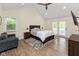 This main bedroom is spacious with wood floors, high ceilings and double doors to the outside at 13300 Fairwood Dr, McCordsville, IN 46055