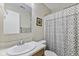 Bright bathroom featuring a framed mirror and patterned shower curtain at 1431 Evergreen Dr, Greenfield, IN 46140