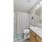 Bathroom featuring shower with floral curtain, a mirror, and a single sink vanity at 1431 Evergreen Dr, Greenfield, IN 46140