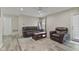 Relaxing living room with a ceiling fan, leather furniture, an area rug and a glass sliding door to the backyard at 1431 Evergreen Dr, Greenfield, IN 46140