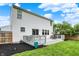 Backyard view featuring the home's white siding, a gray wood deck, and a well-maintained lawn at 14638 Deerwood Dr, Carmel, IN 46033