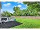 Expansive backyard with lush green grass, a wood fence, and a deck perfect for outdoor entertaining and relaxation at 14638 Deerwood Dr, Carmel, IN 46033