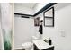 Cozy bathroom featuring a sleek black mirror, a modern sink, and well-lit with white walls and contrasting trim at 14638 Deerwood Dr, Carmel, IN 46033