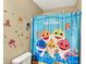 bathroom showcasing a fun baby shark themed shower curtain and matching wall decals for a playful and inviting atmosphere at 14638 Deerwood Dr, Carmel, IN 46033