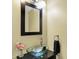 Modern powder room features a glass vessel sink, a sleek black-framed mirror, and a stylish towel ring at 14638 Deerwood Dr, Carmel, IN 46033