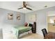 Bright bedroom featuring a ceiling fan, comfortable bed, and a dedicated desk area with easy access to the hallway at 14638 Deerwood Dr, Carmel, IN 46033