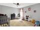 This bedroom features neutral walls, carpet flooring, a ceiling fan, a window, and plenty of play space at 14638 Deerwood Dr, Carmel, IN 46033