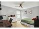This bedroom features neutral walls, carpet flooring, a ceiling fan, a window, and a white dresser for ample storage at 14638 Deerwood Dr, Carmel, IN 46033