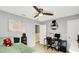 Bedroom with ceiling fan, bed, and a dedicated desk area perfect for work or study and easy access to hallway at 14638 Deerwood Dr, Carmel, IN 46033