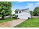 Charming two-story home with a well-manicured lawn and attached two-car garage at 14638 Deerwood Dr, Carmel, IN 46033