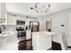 Well-lit kitchen features stainless steel appliances, white cabinetry, an island, and dark hardwood floors at 14638 Deerwood Dr, Carmel, IN 46033