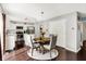 Open kitchen with white cabinetry, stainless steel appliances, and a dining area at 14638 Deerwood Dr, Carmel, IN 46033