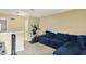 Cozy living room area features a large blue couch, a workout machine, and neutral-toned walls at 14638 Deerwood Dr, Carmel, IN 46033