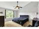 This main bedroom features neutral walls, carpet flooring, a ceiling fan, and a large window for natural light at 14638 Deerwood Dr, Carmel, IN 46033