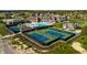 Aerial view of a community featuring tennis courts, a pool, a clubhouse, and lush landscaping at 1475 Old Hickory Ln, Westfield, IN 46074