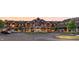 Beautiful sunset view of a large building with an American flag, parking, and lush landscaping at 1475 Old Hickory Ln, Westfield, IN 46074