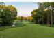Scenic view of a lush green golf course with mature trees and manicured greens at 1475 Old Hickory Ln, Westfield, IN 46074