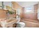 Charming vintage bathroom features tiled walls, vanity, and a bathtub at 1497 Clinton St, Noblesville, IN 46060