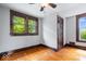 This bedroom has wood trim, hardwood floors, and two large windows at 1497 Clinton St, Noblesville, IN 46060