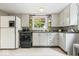 Classic kitchen with vintage cabinetry, black countertops, and ample natural light at 1497 Clinton St, Noblesville, IN 46060