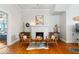Cozy sitting area with warm hardwood floors, fireplace and natural light at 1497 Clinton St, Noblesville, IN 46060